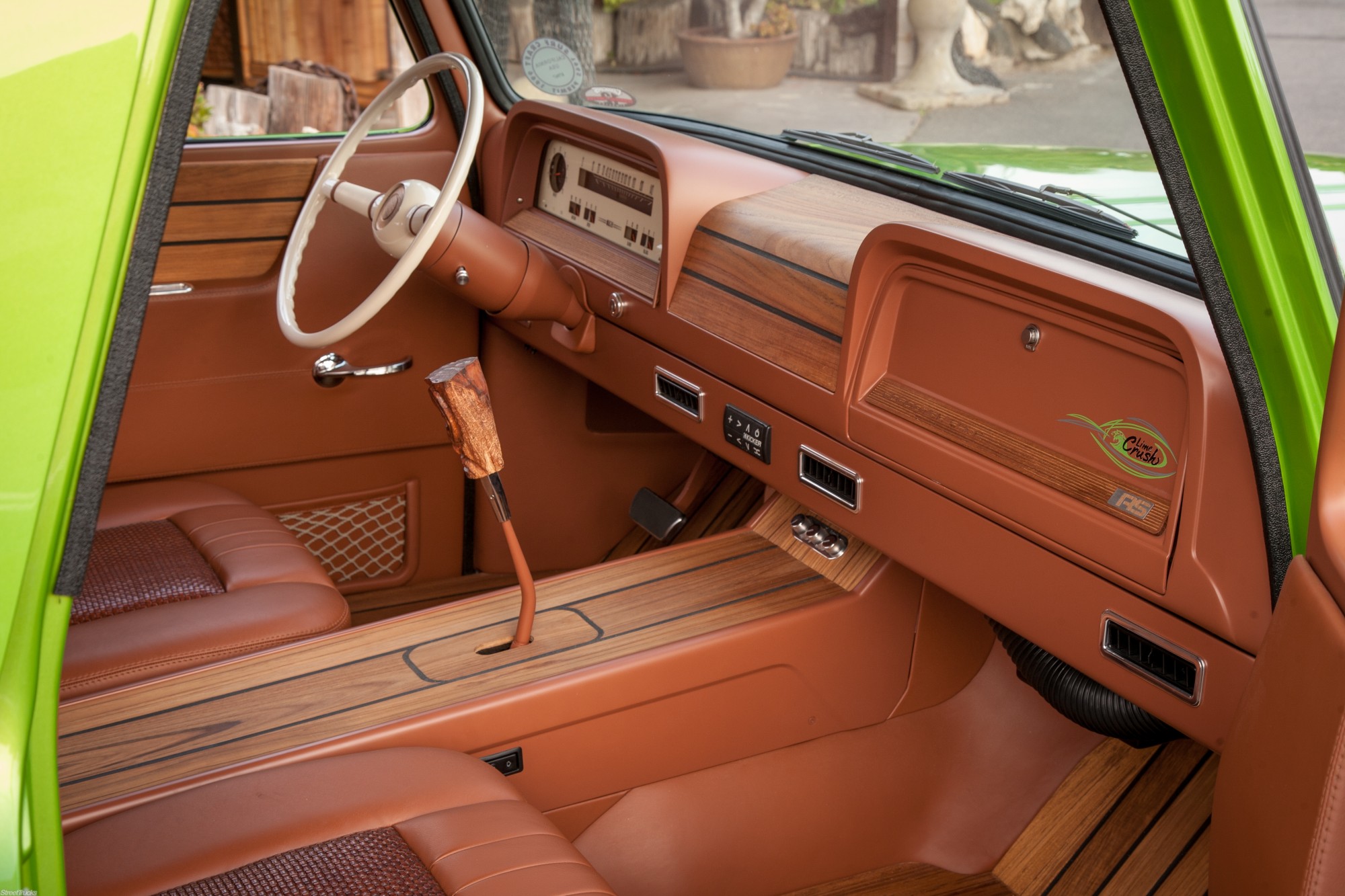 Chevy Suburban interior reupholstered in cognac leather with wood trim